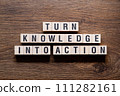 Turn knowledge into action - word concept on building blocks, text 111282161