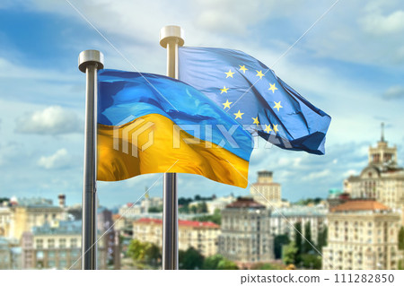Flags of Ukraine and European Union against Kyiv on background Flags of Ukraine and European Union against Kyiv on background 111282850