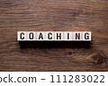 Coaching - word concept on building blocks, text 111283022