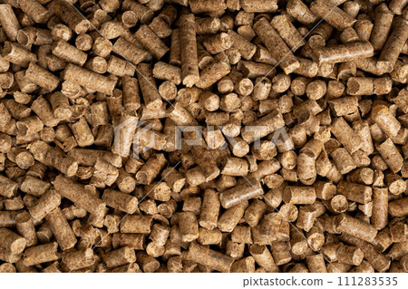Wood pellet background. Close up natural wood pellet. Ecological heating, renewable energies Biofuels. Top view. Flat ecological fuel for solid fuel boilers 111283535