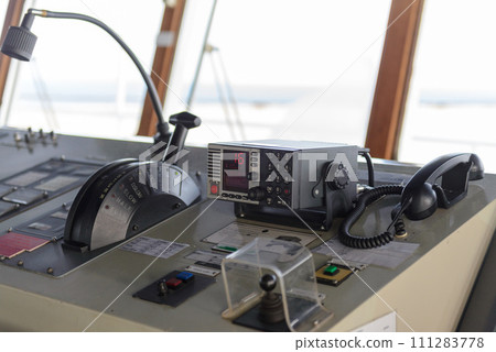 Navigational control panel with hand. Ship engine control. Navigational bridge. Navigational control panel with hand. Ship engine control. Navigational bridge. 111283778