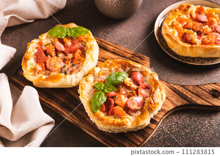 Chicago pizza pot pie with tomatoes, cheese and sausage on a wooden board Chicago pizza pot pie with tomatoes, cheese and sausage on a wooden board 111283815