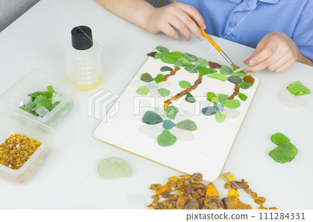 Sea glass is small polished pieces of broken bottles and other glass products collected on the beach and pieces of amber. A gift for a holiday on March 8, birthday, mother's day. Sea glass is small polished pieces of broken bottles and other glass products collected on the beach and pieces of amber. A gift for a holiday on March 8, birthday, mother's day. 111284331