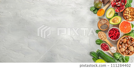 Healthy vegan food with fruits, vegetables, seeds, superfood, cereals. Foods high in vitamins, minerals and antioxidants. Long banner format. top view Healthy vegan food with fruits, vegetables, seeds, superfood, cereals. Foods high in vitamins, minerals and antioxidants. Long banner format. top view 111284402