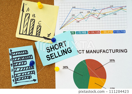 Reporting graphs and diagrams are hung on the board, a sticker with the inscription - Short selling Reporting graphs and diagrams are hung on the board, a sticker with the inscription - Short selling 111284423