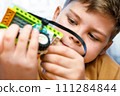 Smart child science class robotics kids technology child constructor robotics learning technology toy. Little boy makes robot toy car. Kids stem education. Smart boy assemble constructor kids workshop 111284844