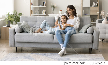 Happy young mom and sweet kid girl enjoying homey leisure 111285234