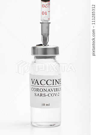 Medicine bottle with coronavirus vaccine covid-19. Medical glass vial and syringe for vaccination. liquid vaccine in laboratory, hospital or pharmacy concept isolated on white background Medicine bottle with coronavirus vaccine covid-19. Medical glass vial and syringe for vaccination. liquid vaccine in laboratory, hospital or pharmacy concept isolated on white background 111285312