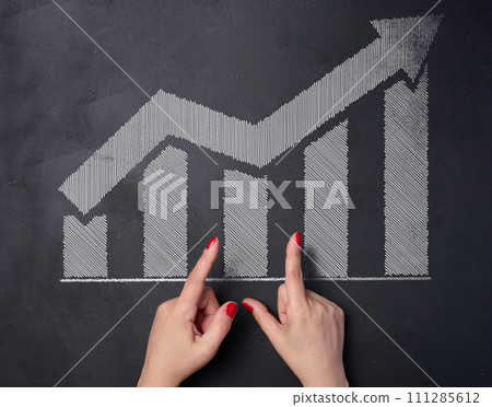 White chalk drawn graph columns and up arrow, indicator growth concept 111285612