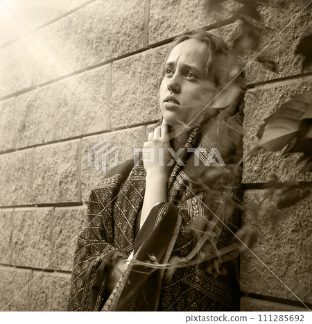Sad girl near the wall 111285692