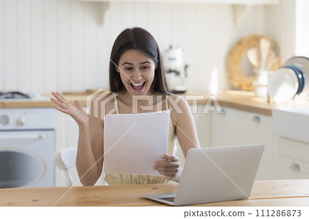 Overjoyed woman hold letter read good news 111286873