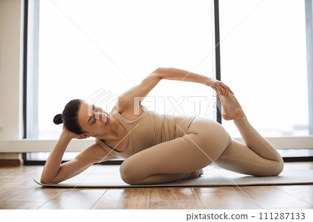 Caucasian lady doing achieving advanced Mermaid Pose. Caucasian lady doing achieving advanced Mermaid Pose. 111287133