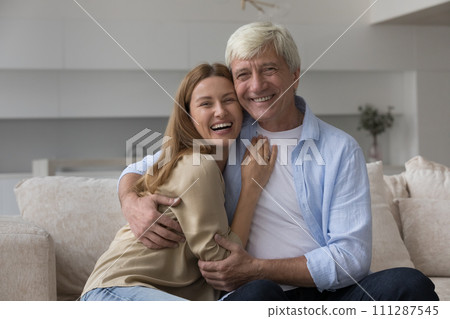 Happy millennial woman hugs her elderly father Happy millennial woman hugs her elderly father 111287545