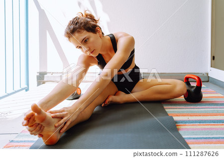 teenage girl doing yoga at home on balcony teenage girl doing yoga at home on balcony 111287626