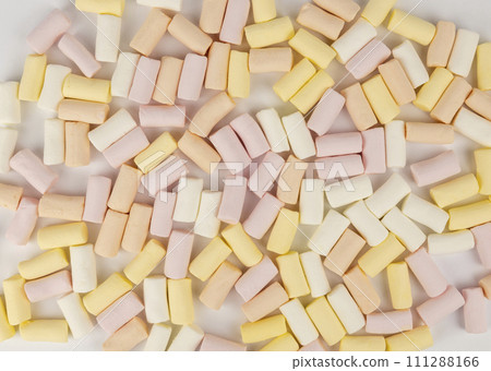 Pink yellow and white marshmallow background. The concept of colored marshmallows. Pink yellow and white marshmallow background. The concept of colored marshmallows. 111288166