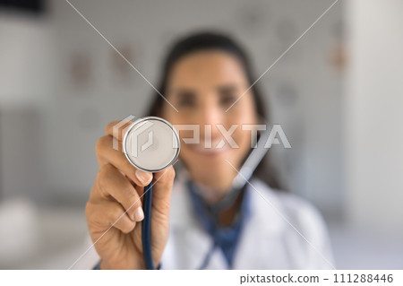 Hand of young doctor woman showing stethoscope at camera 111288446