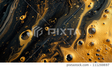 Macro shot of golden swirls with black bubbles creating a mesmerizing abstract texture reminiscent of cosmic phenomena or luxurious marbled surfaces. 111288697
