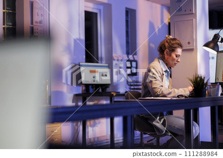 Businesswoman planning financial investment report, typing company strategy using computer keyboard. Executive manager working overtime at marketing project in startup office. Corporate concept Businesswoman planning financial investment report, typing company strategy using computer keyboard. Executive manager working overtime at marketing project in startup office. Corporate concept 111288984