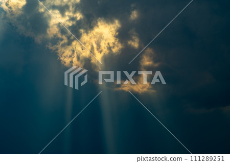 Crepuscular rays of light shining through the gap between thick clouds b-1 Crepuscular rays of light shining through the gap between thick clouds b-1 111289251