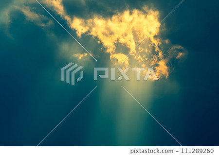 Crepuscular rays of light shining through gaps in thick clouds f-2 Emphasis on warm and cool colors 111289260