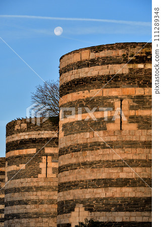 Angers, France. Angers castle and the moon in the morning. Photographed on December 29, 2023. 111289348