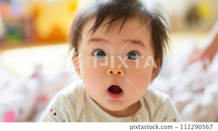 Adorable Japanese baby's eyes sparkle with discovery 111290567