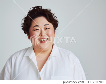 Portrait of a chubby Asian woman with a bright smile 111290700