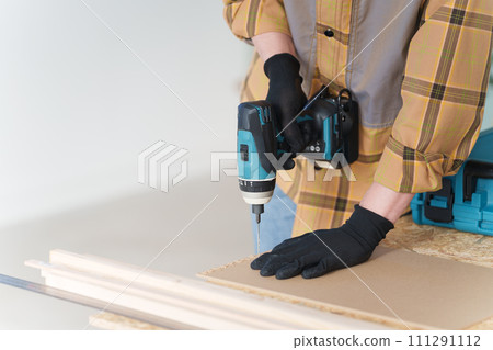 Middle-aged man doing DIY at home Middle-aged man doing DIY at home 111291112