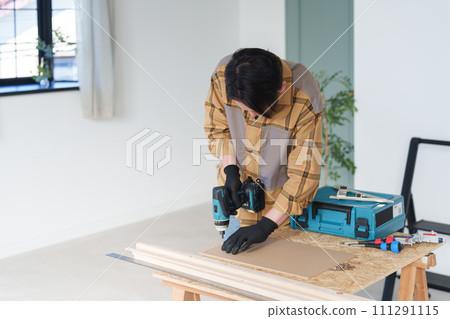 Middle-aged man doing DIY at home Middle-aged man doing DIY at home 111291115