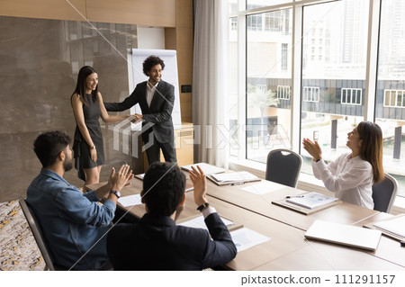 Happy young company leader shaking hands with best manager 111291157