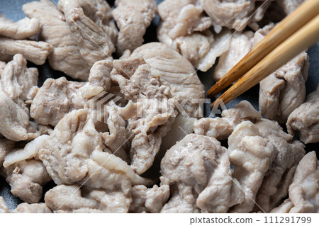 A cooking scene where pork (cut off thighs) is stir-fried in a frying pan. A cooking scene where pork (cut off thighs) is stir-fried in a frying pan. 111291799
