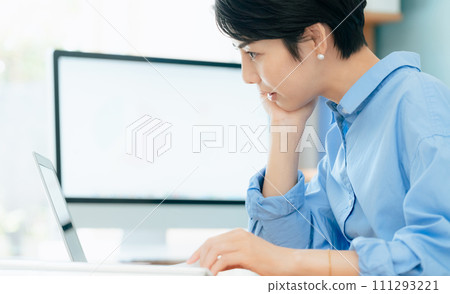 A woman working on a computer A woman working on a computer 111293221