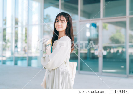 Female college student walking on campus 111293483