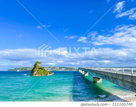 Blue sea, Kouri Island and Kouri Ohashi Bridge in Okinawa Prefecture 111293740