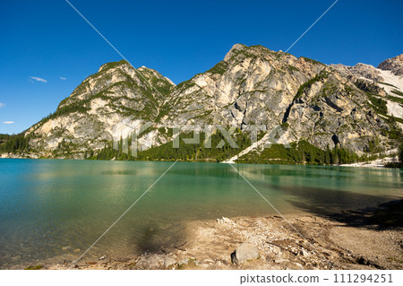 Emerald alpine lake Braies in Prags valley surrounded by Dolomites 111294251