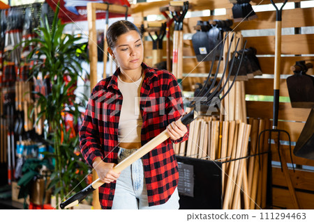 Young woman selects working tools and checks them 111294463