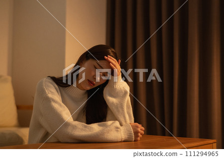 A woman who feels unwell or has a cold at night 111294965