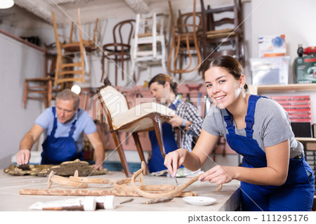 Restorer woman carefully cleans dirt and dust from carved wooden decor element Restorer woman carefully cleans dirt and dust from carved wooden decor element 111295176