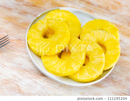 Pineapple rings served on table Pineapple rings served on table 111295204