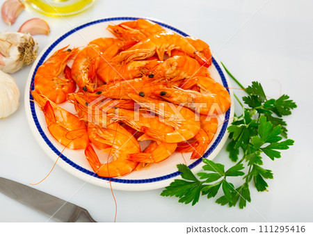 Seafood appetizer. Roasted langostins served with parsley 111295416