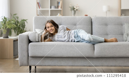 Happy positive lazy pre teen kid girl enjoying leisure, relaxation Happy positive lazy pre teen kid girl enjoying leisure, relaxation 111295418