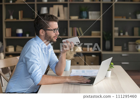 Businessman holding smartphone talk to client using speakerphone 111295460