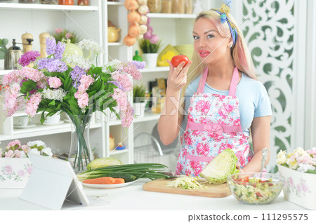 Young woman cooking healthy food in kitchen 111295575