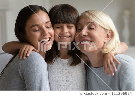 Head shot portrait happy three generations of women hugging 111296954