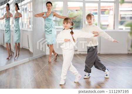 Boy and girl train to dance contemporary vigorous boogie woogie during classes. Boy and girl train to dance contemporary vigorous boogie woogie during classes. 111297195