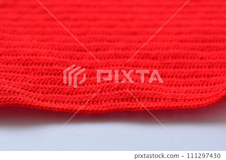 red wool knitted yarn texture, woolen fabric on white background 111297430