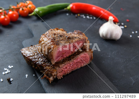 Grilled beef steak ribeye rare on on dark background 111297489