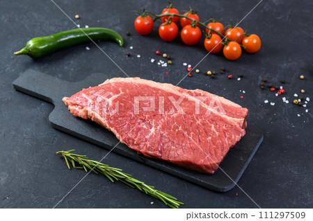Raw fresh marbled meat and seasonings on dark background 111297509