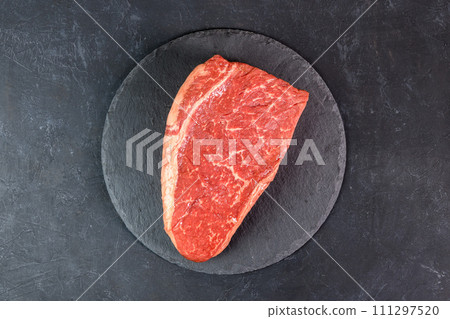 Raw fresh marbled meat on dark background top view Raw fresh marbled meat on dark background top view 111297520