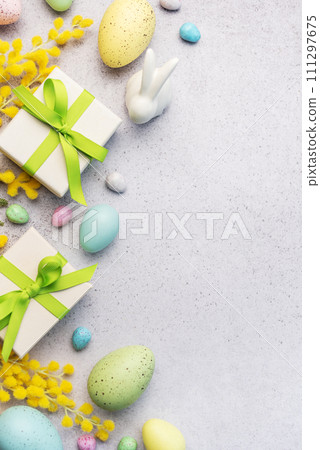 Festive Easter Celebration With Decorated Eggs and Gifts on a Light Background 111297675